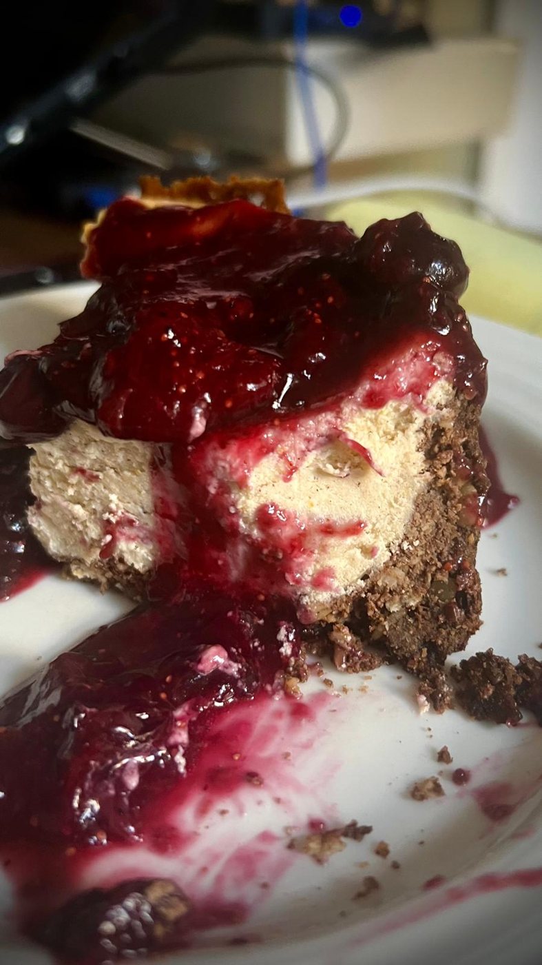 A slice of BluBerry cheesecake, crowned with blueberries and figs